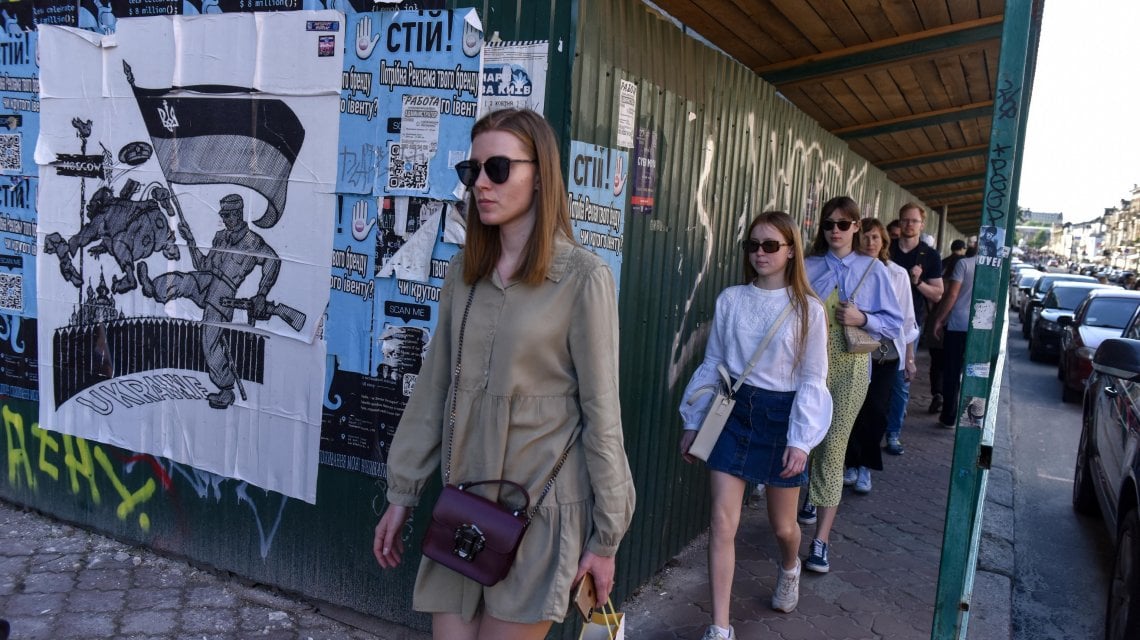 People pass anti-war posters during Kyiv Day celebrations in Kyiv (Kiev), Ukraine, 29 May 2022. Ukraine\'s capital celebrates the anniversary of its foundation every last Sunday of May