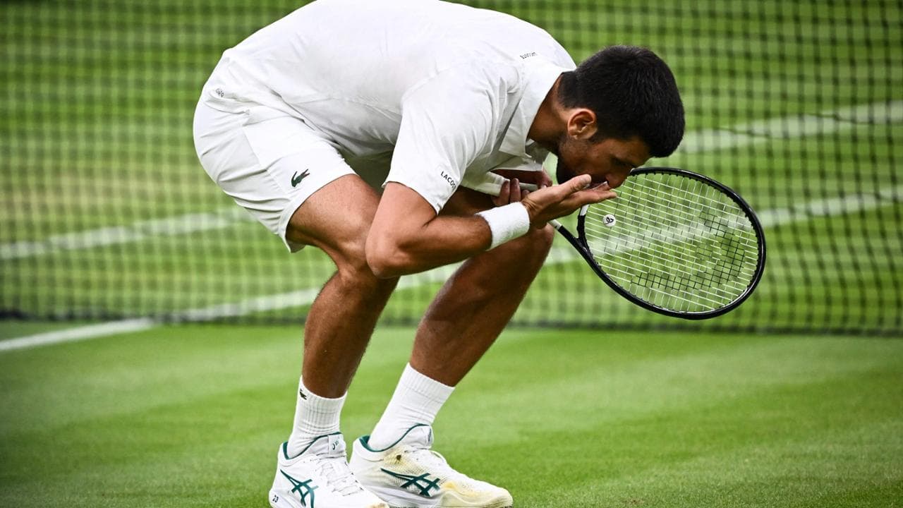 Novak Djokovic bacia l'erba di Wimbledon dopo la vittoria su Jannik Sinner
