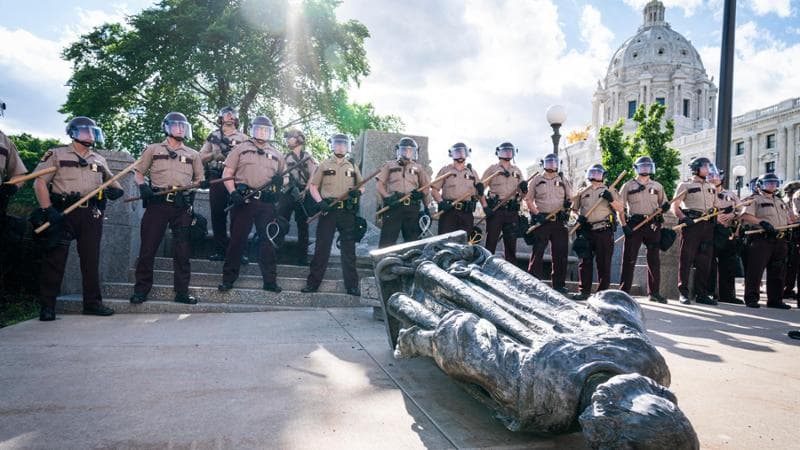 SAINT PAUL, MN,- JUNE 10: Minnesota State Troopers surrounded the statue after it was toppled, until it could be taken away by a tow truck. Activists pulled down the statue of Christopher Columbus in front of the Minnesota State Capitol in St. Paul on Wednesday, June 10, 2020. (Photo by Leila Navidi/Star Tribune via Getty Images)