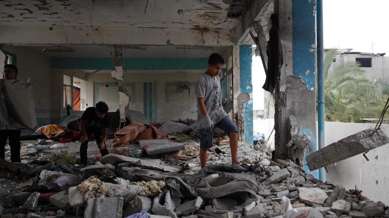 TOPSHOT - Palestinians check a UN-school housing displaced people that was hit during Israeli bombardment in Nuseirat, in the central Gaza Strip, on June 6, 2024, amid the ongoing conflict between Israel and the Palestinian Hamas militant group. The Israeli military said on June 6 its fighter jets had struck a UN-run school used by Palestinian militants in central Gaza, with authorities in the Hamas-run territory reporting at least 27 dead. (Photo by Bashar TALEB / AFP)