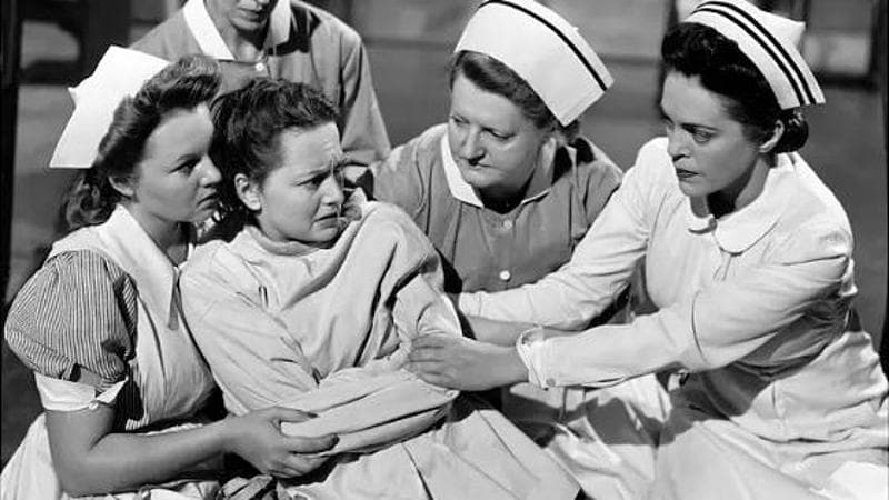 Al centro della foto, Olivia de Havilland è Virginia Stuart in La fossa dei serpenti di Anatole Litvak: il film è del 1948