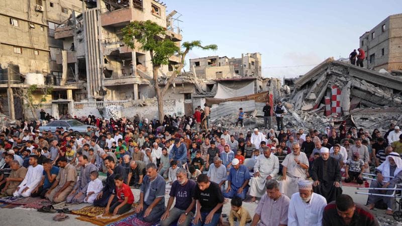 Palestinians perform the Eid al-Adha morning prayer in Khan Yunis in the southern Gaza Strip, on the first day of the Muslim holiday marking the end of the hajj pilgrimage to Mecca, on June 16, 2024. (Photo by Bashar TALEB / AFP)