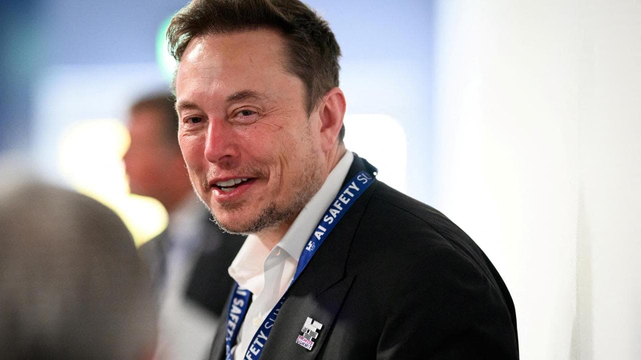 FILE PHOTO: Tesla, X (formerly known as Twitter) and SpaceX's CEO Elon Musk speaks with other delegates on Day 1 of the AI Safety Summit at Bletchley Park in Bletchley, Britain on November 1, 2023. Leon Neal/Pool via REUTERS/File Photo