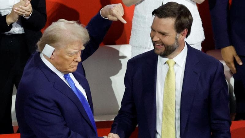 FILE PHOTO: Republican presidential nominee and former U.S. President Donald Trump shakes hands with vice presidential nominee J.D. Vance as he arrives to attend Day 2 of the Republican National Convention (RNC), at the Fiserv Forum in Milwaukee, Wisconsin, U.S., July 16, 2024. REUTERS/Marco Bello/File Photo
