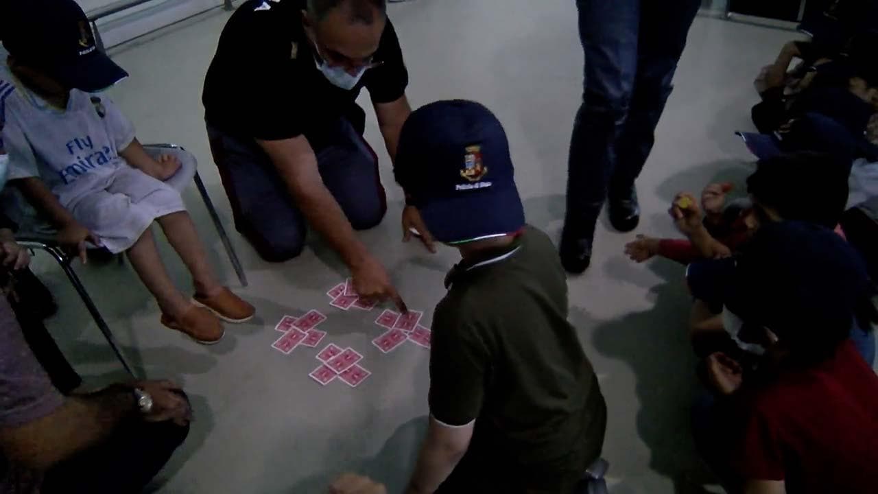 Fiumicino, poliziotti accolgono i bambini che arrivano da Kabul: ai piccoli fanno giochi di prestigio