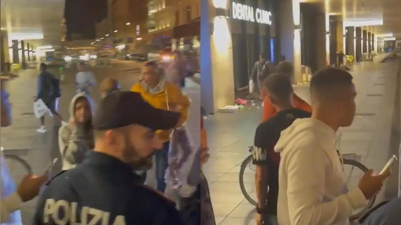 Il calciatore del Napoli Juan Jesus consegna due buste col cibo ai clochard della stazione Termini