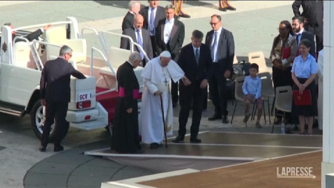 Papa Francesco arriva all'udienza con il bastone: i collaboratori lo aiutano a raggiungere il palco