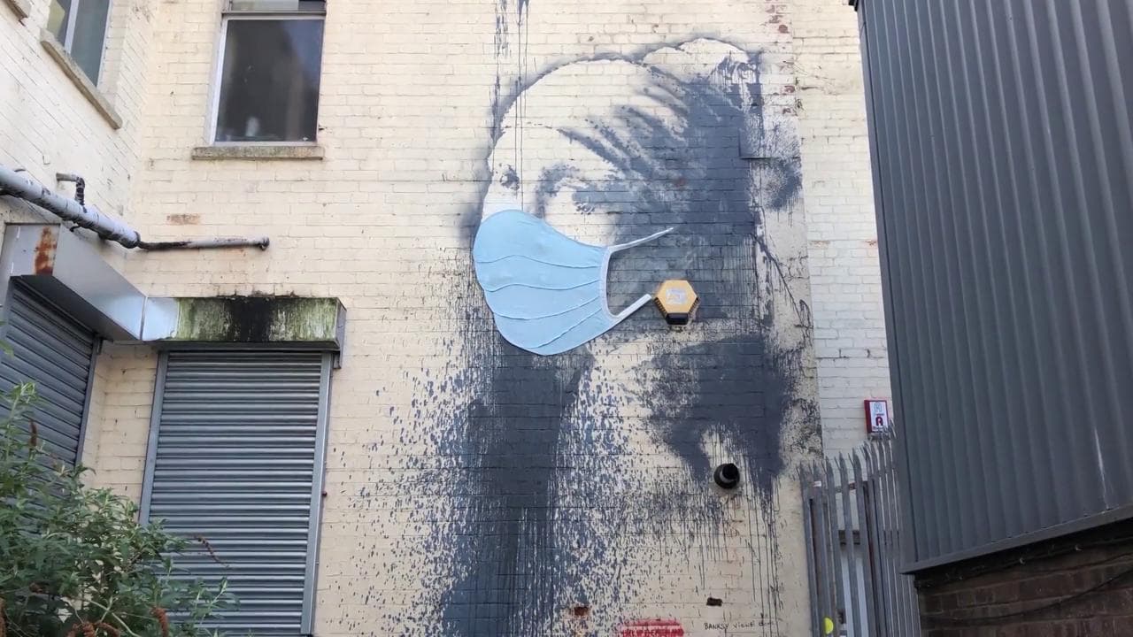 Coronavirus, la 'ragazza con l'orecchino' di Banksy protetta da una mascherina: il blitz sul muro di Bristol