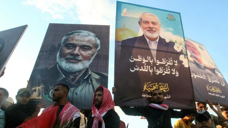 People take part in a march called by Palestinian and Lebanese youth organisations in the southern Lebanese city of Saida, on August 5, 2024, to protest against the assassination of Hamas chief Ismail Haniyeh (portrait) and a Hezbollah military commander. Urgent calls grew for foreign nationals to leave Lebanon, which would be on the front line of a regional war, as Iran and its allies readied their response to high-profile killings blamed on Israel. (Photo by Mahmoud ZAYYAT / AFP)