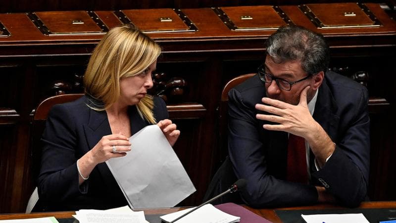 Italian Prime Minister, Giorgia Meloni (L), with Italian Minister of Economy, Giancarlo Giorgetti (R), ahead of a confidence vote for the new government, at the Chamber of Deputies, the lower house of parliament, in Rome, Italy, 25 October 2022. ANSA/RICCARDO ANTIMIANI