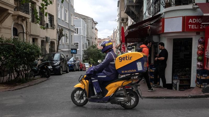 A courier delivers food for rapid grocery delivery company Getir in Istanbul, Turkey, on Friday, May 10, 2024. The public spending frenzy that Turkish President&nbsp;Recep Tayyip Erdogan&nbsp;built his political career on is set to cool as the government prepares to freeze new projects in order to focus on fighting inflation. Photographer: Nicole Tung/Bloomberg via Getty Images