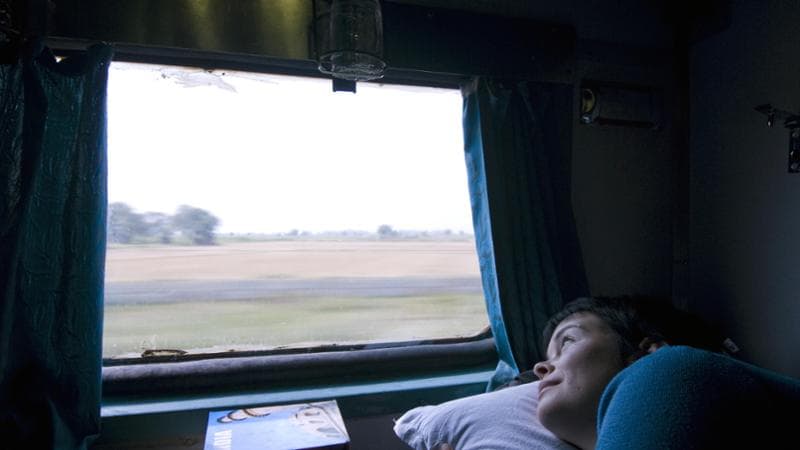 Woman looking out window of train carriage