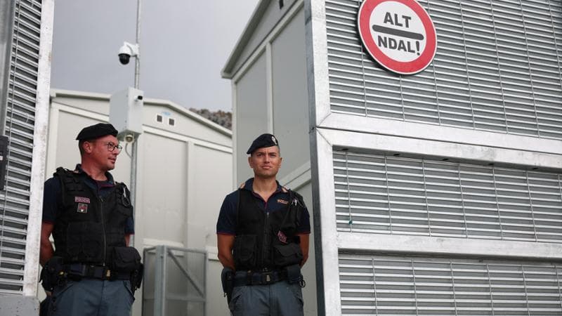 Italian police officers stand inside the reception camp at the port where Italy will process illegal migrants, in Shengjin, Albania October 11, 2024. REUTERS/Florion Goga