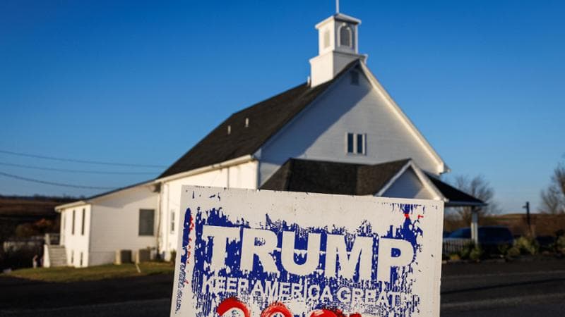 (FILES) A pro-Trump campaign signs sit across the intersection from the voting location in Benders Mennonite Church on Election Day in Pen Argyl, Pennsylvania on November 5, 2024. Rural voters helped propel Donald Trump to a resounding victory, providing a boost as he outperformed pollster predictions and his past performances at the ballot box. Painting a picture of a neglected US heartland overlooked by urban elites, Trump's campaign placed rural Americans at the heart of its divisive effort to whip up support. (Photo by SAMUEL CORUM / AFP)