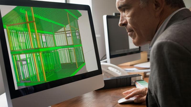 Architects discussing a green construction project, designing and building efficient environmentally friendly buildings. Green architectural practice.