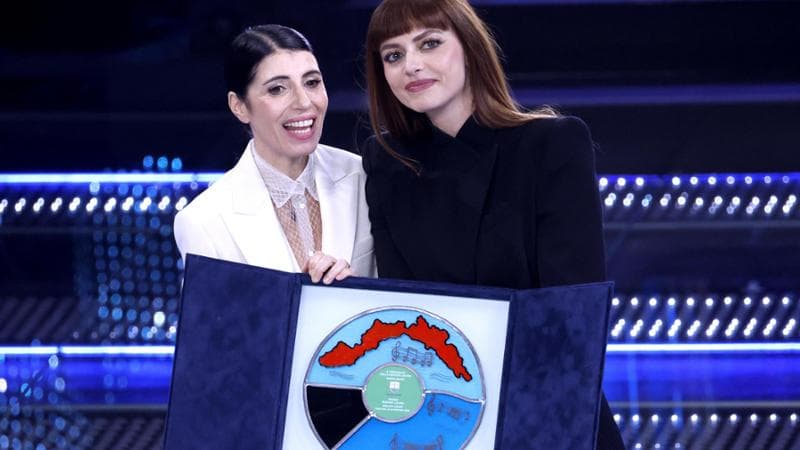 Italian singers Giorgia (L) and Annalisa pose with the trophy for the Best Cover on stage at the Ariston theatre during the 75th edition of the Sanremo Italian Song Festival, in Sanremo, Italy, 14 February 2025. The music festival will run from 11 to 15 February 2025.  ANSA/FABIO FRUSTACI