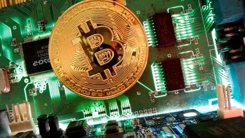 FILE PHOTO: Representation of the virtual currency bitcoin is seen on a motherboard in this picture illustration taken April 24, 2020. REUTERS/Dado Ruvic/Illustration/File Photo