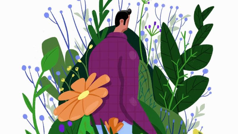 Man walking through flowers