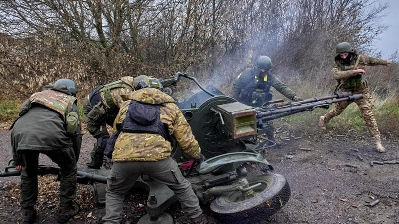epa10300722 Members of Ukraine's National Guard operate an anti-aircraft gun at a position not far from Kharkiv, northeastern Ukraine, 11 November 2022, amid Russia's invasion. Kharkiv and surrounding areas have been the target of heavy shelling since February 2022, when Russian troops entered Ukraine starting a conflict that has provoked destruction and a humanitarian crisis. At the beginning of September, the Ukrainian army pushed Russian forces from occupied territory in the northeast of the country in counterattacks.  EPA/SERGEY KOZLOV