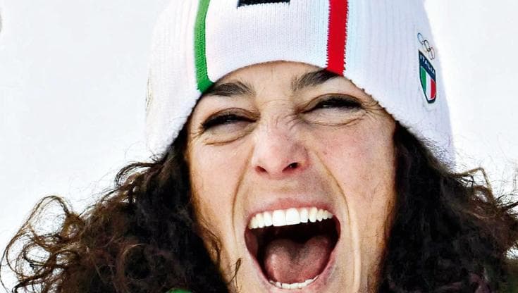 Italy's gold medalist Federica Brignone celebrates on the podium of the women's super-G event during the Milano Cortina 2026 Winter Olympic Games at the Tofane Alpine Skiing Centre in Cortina d’Ampezzo on February 12, 2026. (Photo by Stefano RELLANDINI / AFP)