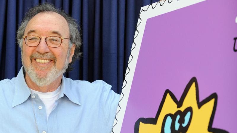 James L. Brooks nel 2009 accanto a un’immagine di Maggie Simpson. (Getty images)