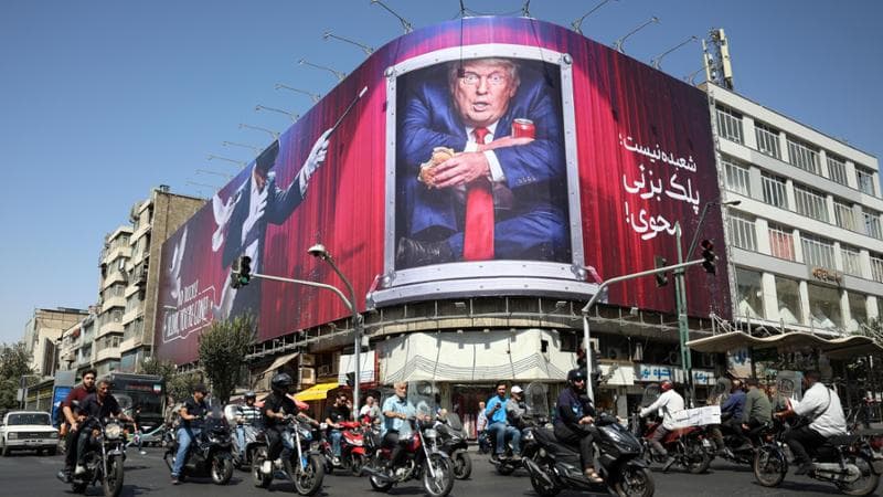 epa13219148 People drive motorcycles past an anti-US President Donald Trump billboard in central Tehran, Iran, 07 September 2026, as the conflict between Iran and the US continues, with both sides trading fire in recent days.  EPA/ABEDIN TAHERKENAREH RESTRICTIONS: ISRAEL OUT - NO Access Israel Media/Persian Language TV Stations Outside Iran/Strictly No Access BBC Persian/VOA Persian/Manoto TV/Iran International TV. (As mandated by Iran's Directorate General for Foreign Media)