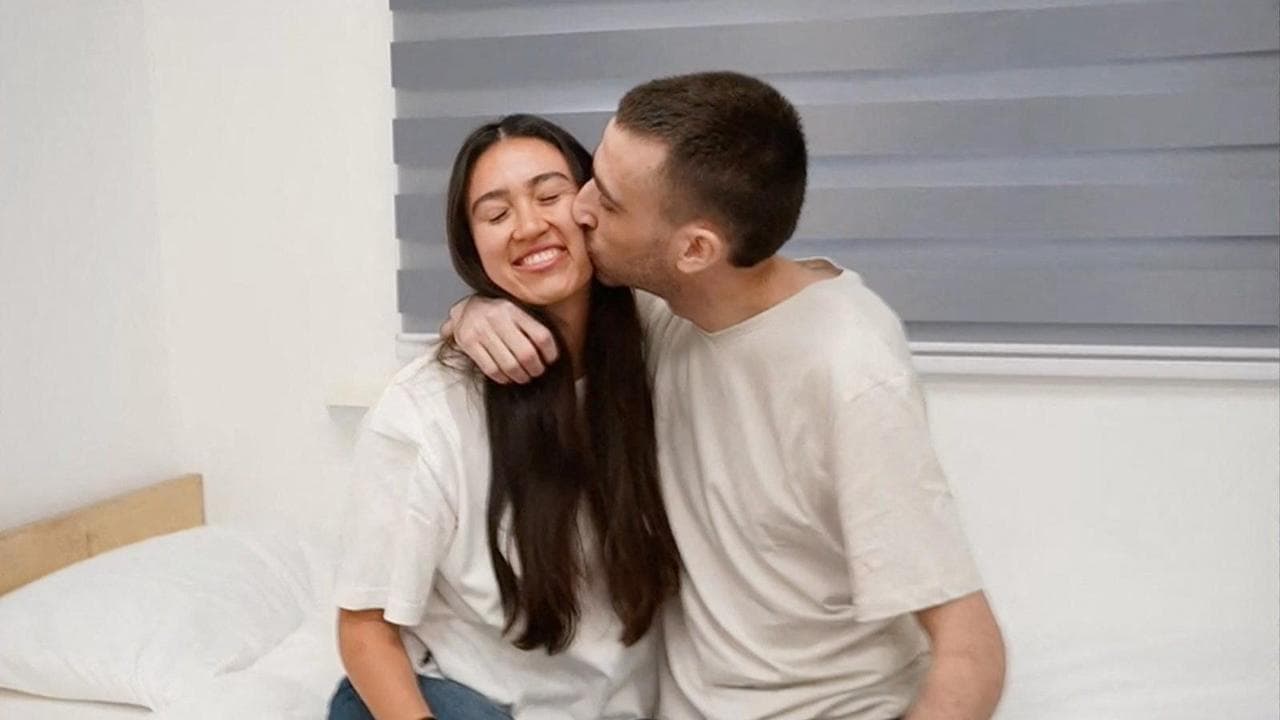 Released Israeli hostage, Avinatan Or, held in Gaza since the deadly October 7, 2023 attack by Hamas, kisses his girlfriend, Noa Argamani, who was also taken hostage and rescued in 2024, after his release as part of a prisoner-hostage swap and a ceasefire deal between Israel and Hamas, in Reim, Israel October 13, 2025. Courtesy of Israel Defense Forces/Handout via REUTERS     THIS IMAGE HAS BEEN SUPPLIED BY A THIRD PARTY    