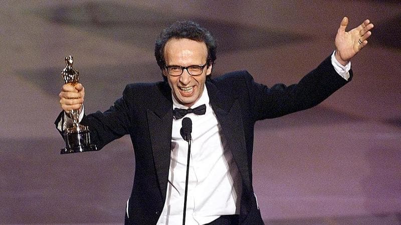 Robero Benigni holds his Oscar after winning the Best Performance by an Actor in a Leading Role for his part in the movie "Life is Beautiful" during the 71st Academy Awards, 1999