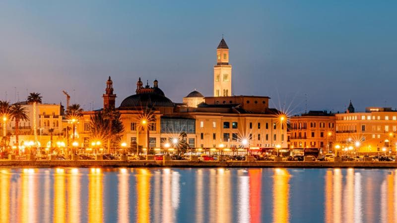 Bari skyline and Adriatic sea coast illuminated at dusk