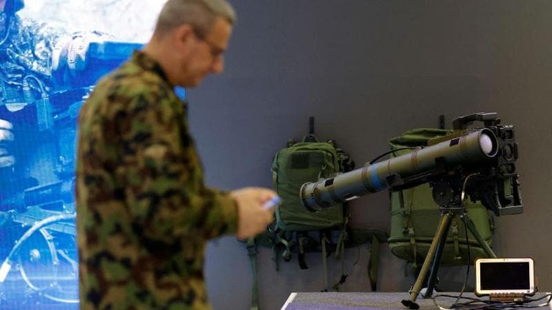 A Swiss Army member walks past a Spike LR2 missile during a presentation of military equipment in Thun (2024)